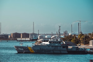 a coast guard boat in the water near a dock