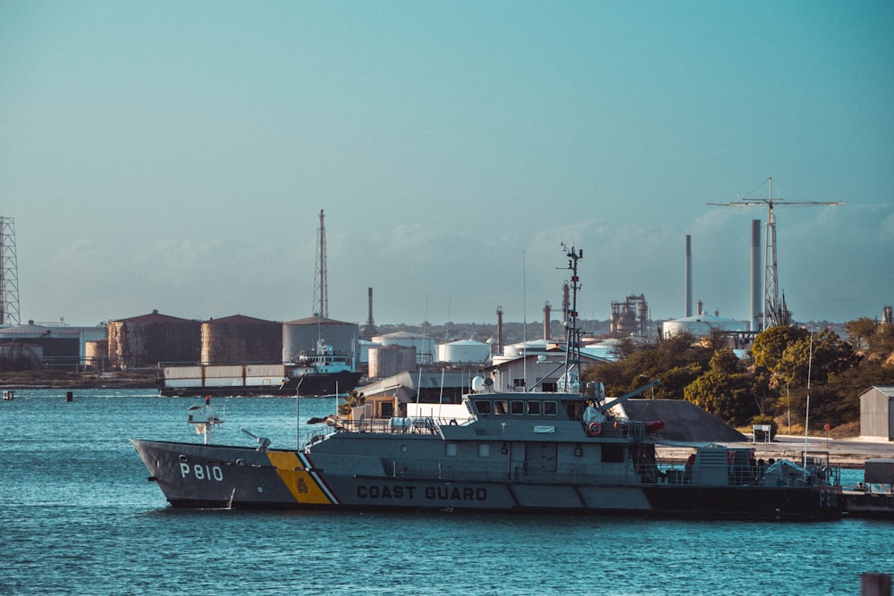 a coast guard boat in the water near a dock