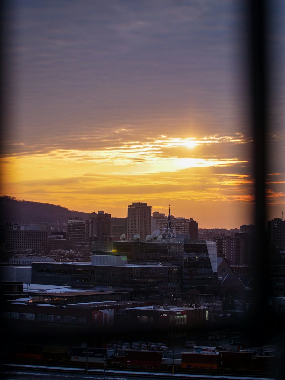 a view of a city at sunset from a window