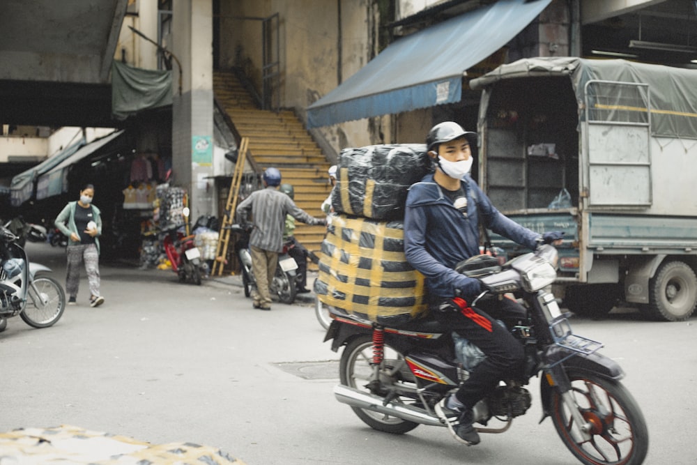 a man riding a motorcycle down a street