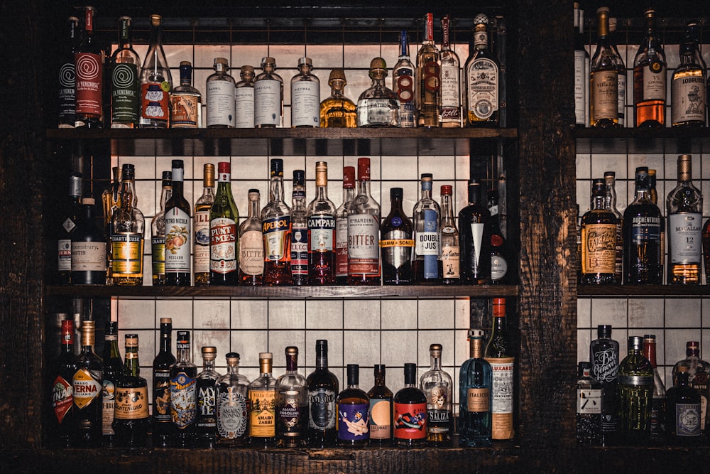 a shelf filled with lots of bottles of alcohol