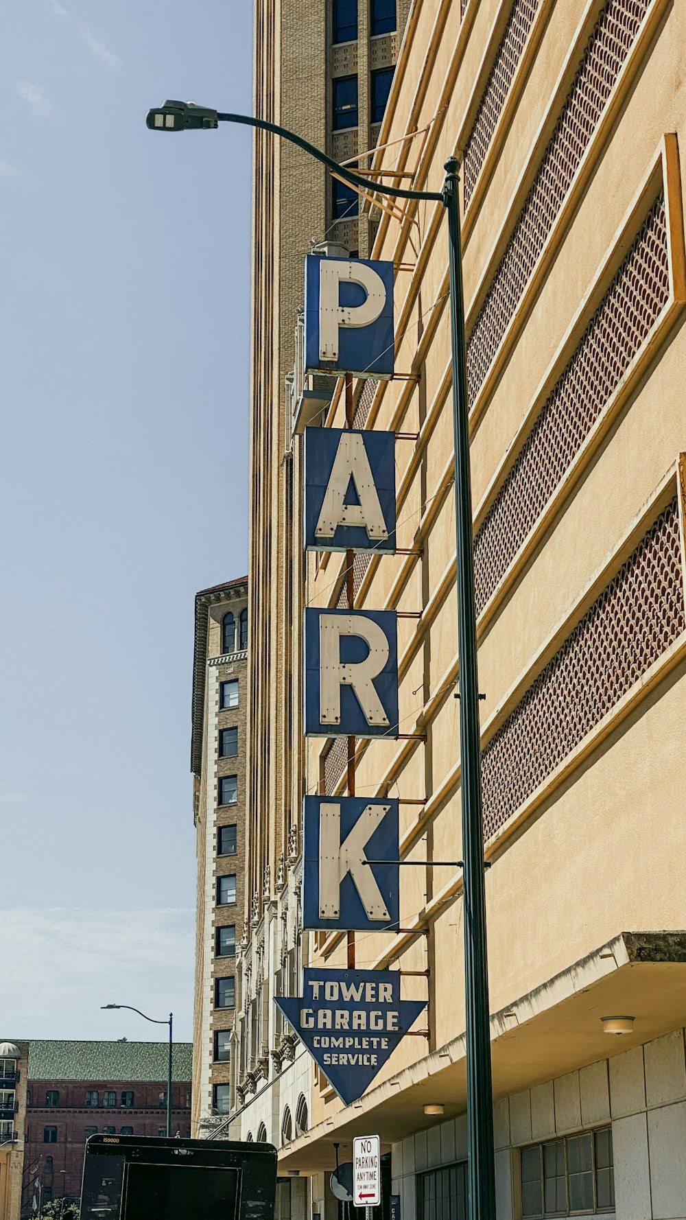 a parking sign on the side of a building