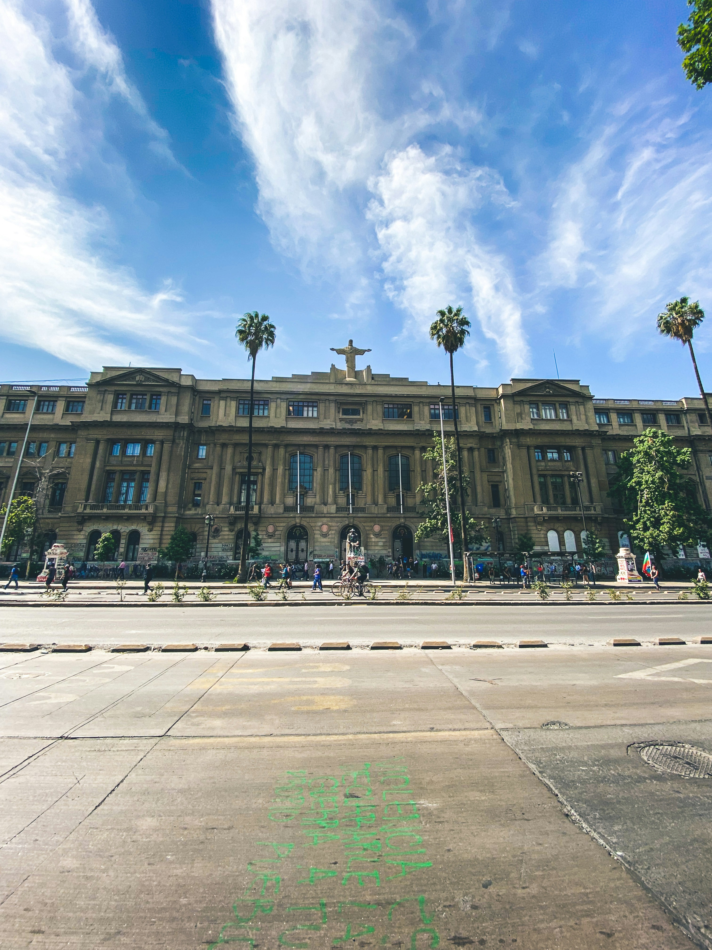 a large building with palm trees in front of it