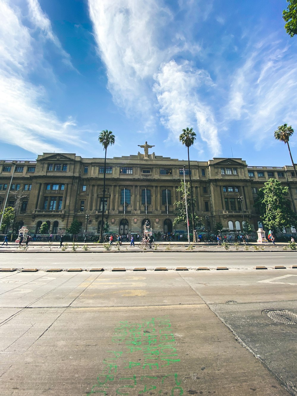 a large building with palm trees in front of it