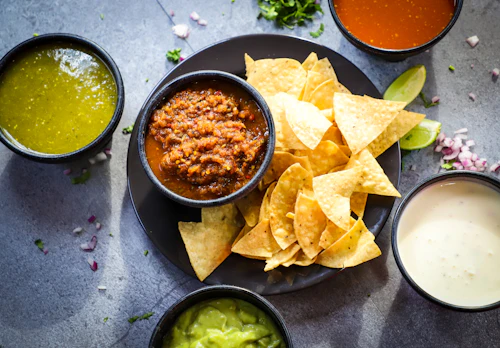 Bowls of freshly made red and green salsa