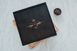 Close-up of a delicate laser-cut wooden wedding keepsake with engraved names and date.