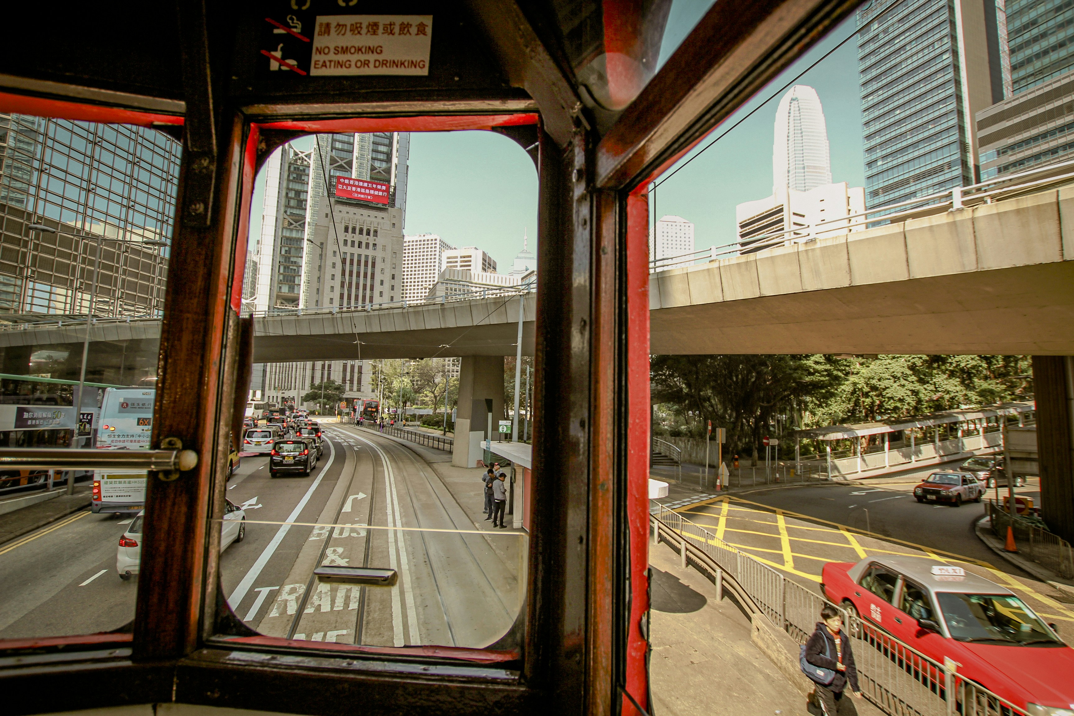How to Navigate Public Transportation Like a Pro in Any Foreign City – a view of a city street from a bus window