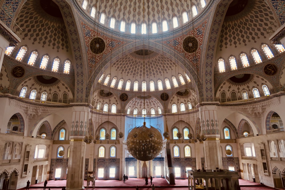 the inside of a large building with a chandelier hanging from the ceiling