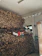 A happy customer stacking a pallet of Fiammaviva pellet bags in a cozy home setting.