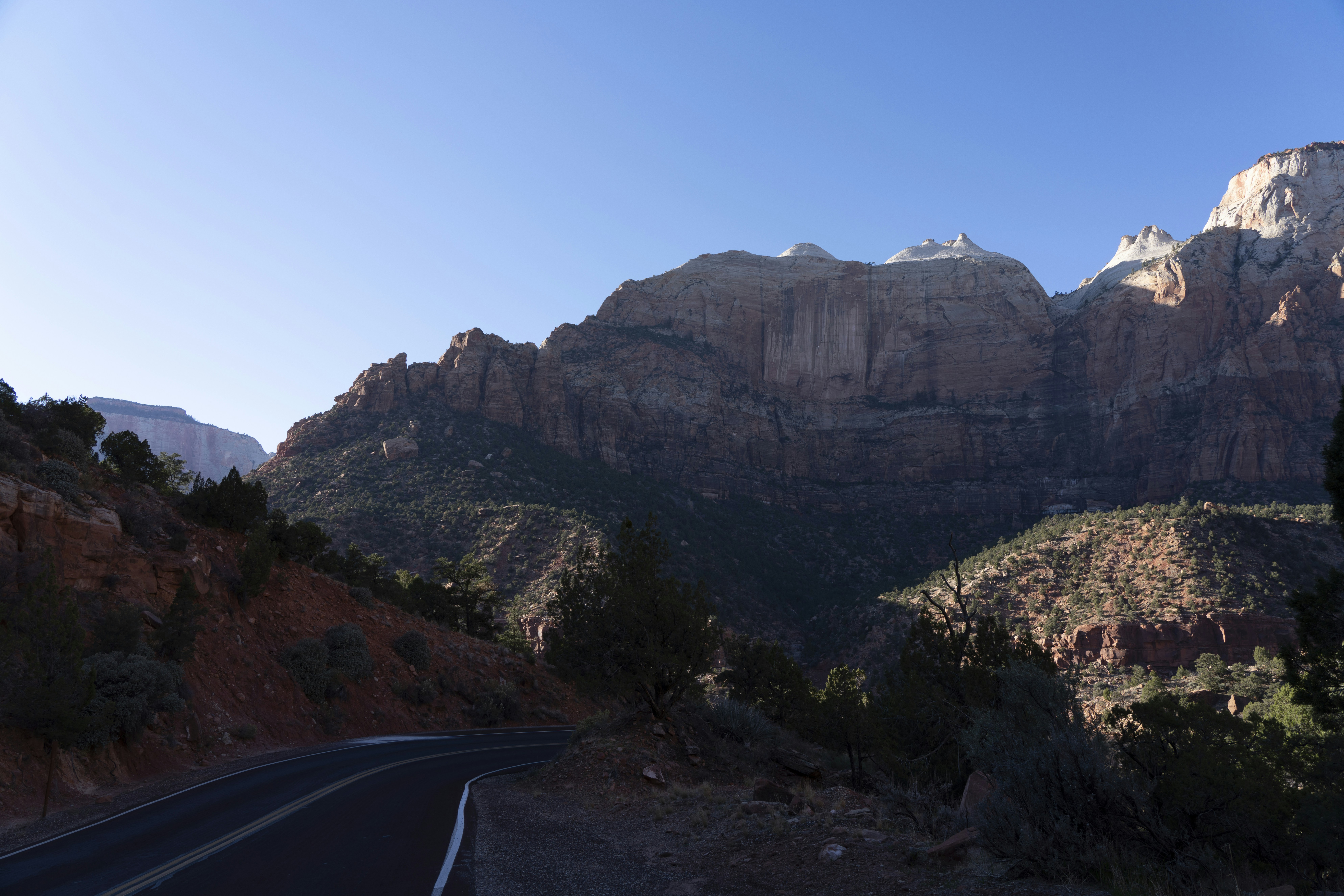 a road with a mountain in the background, 