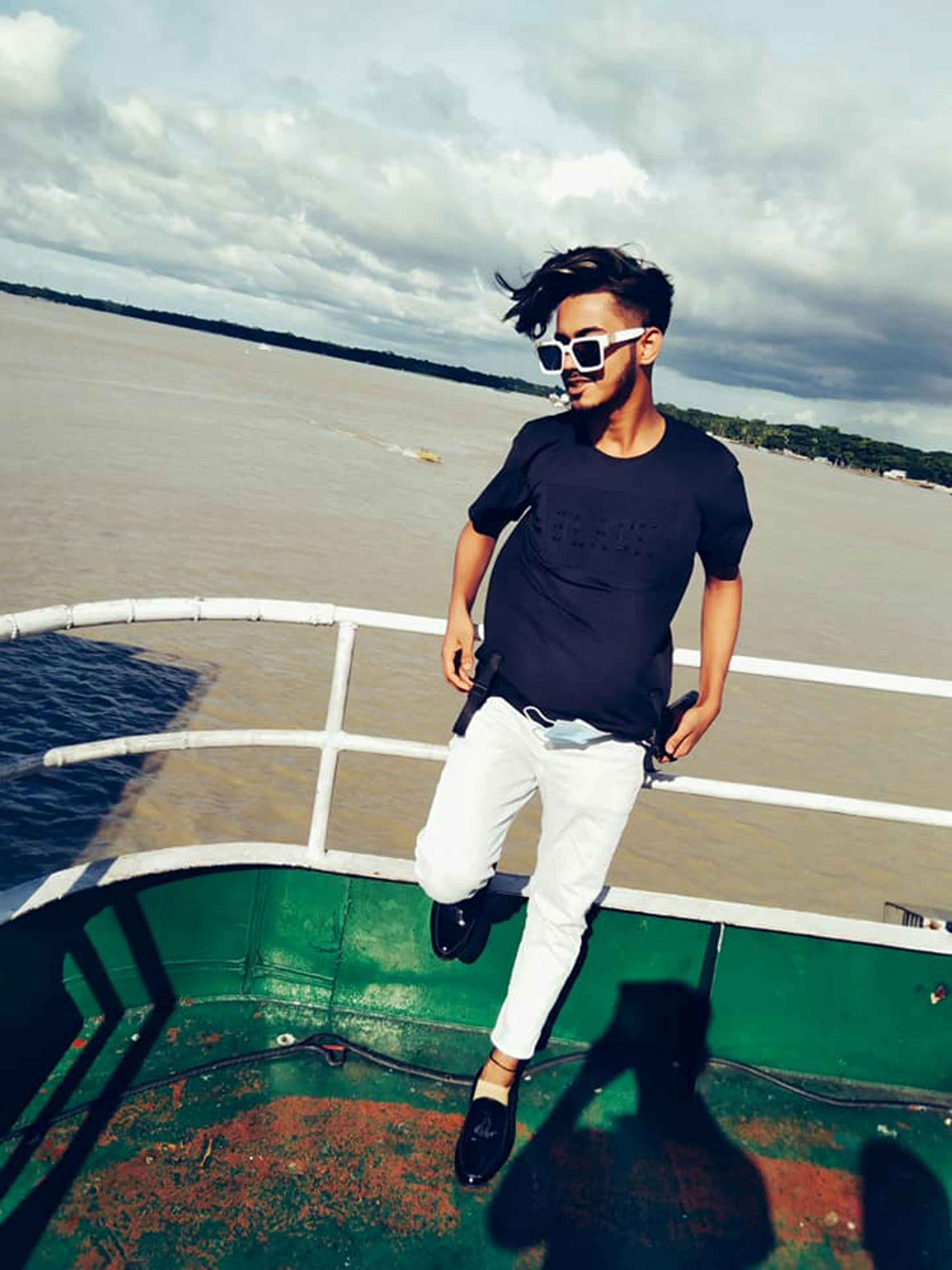 A man standing on a boat in the water photo – Free Ship Image on Unsplash
