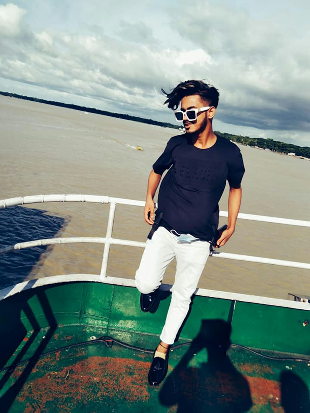 a man standing on a boat in the water