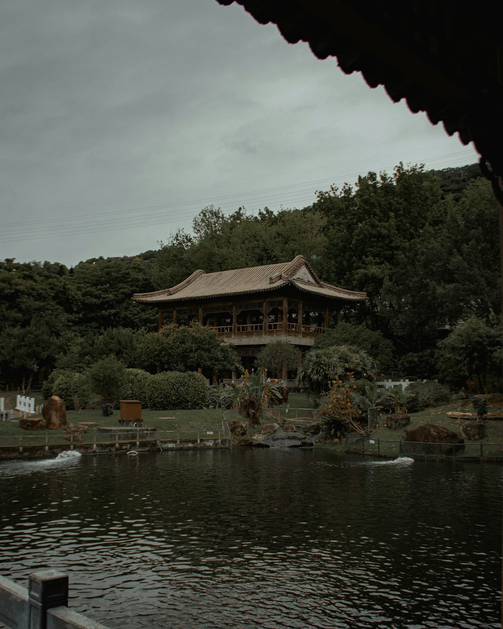 a building sitting on top of a lush green hillside