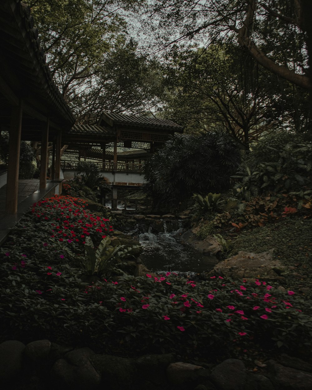 a gazebo surrounded by flowers and trees