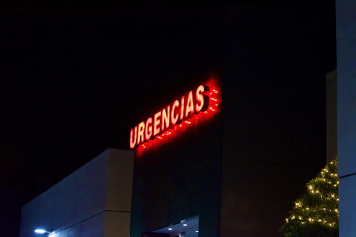 a tall building with a lit up sign on it's side