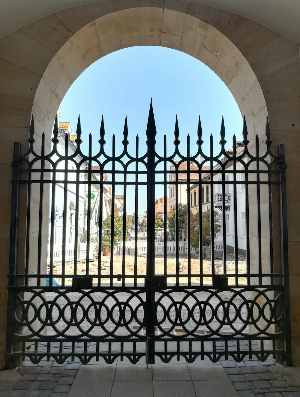 a gate that has a black iron fence in front of it