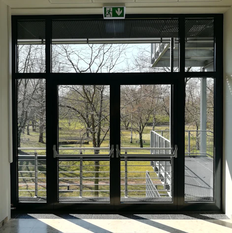 a view of a park through a glass door