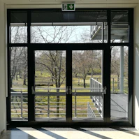 a view of a park through a glass door