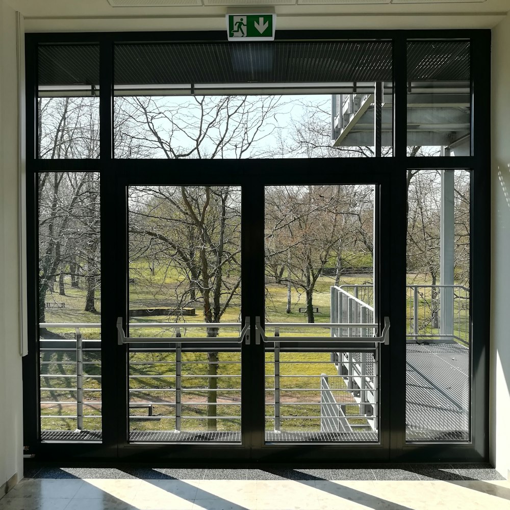 a view of a park through a glass door