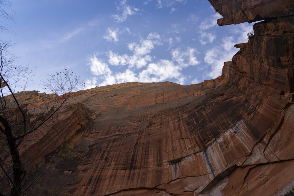 a view of a cliff with a sky in the background