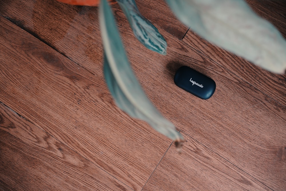 a remote control sitting on top of a wooden floor