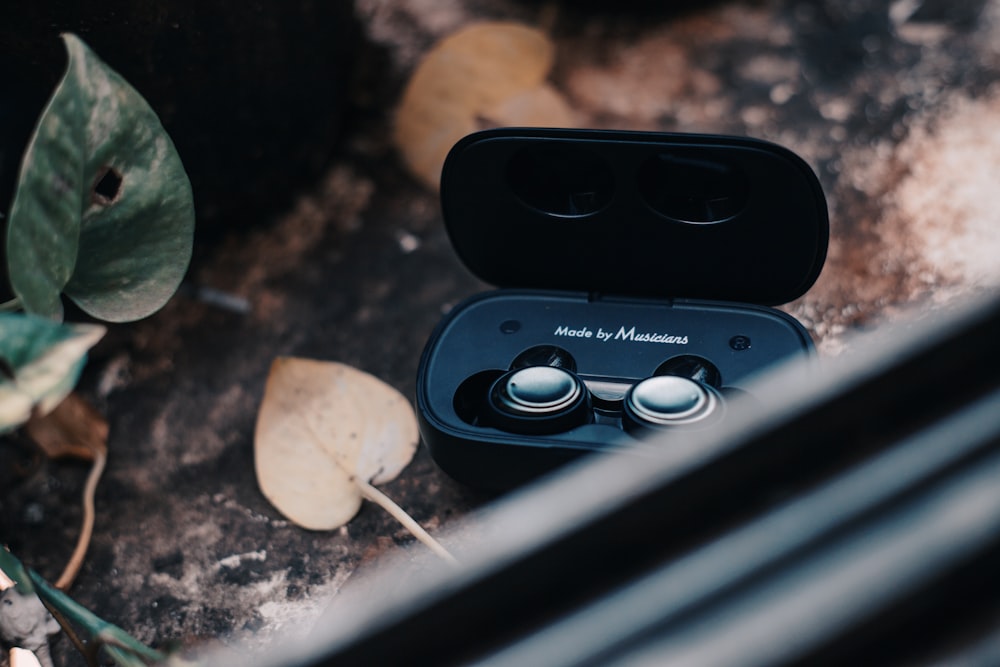 a pair of headphones sitting on top of a wooden table