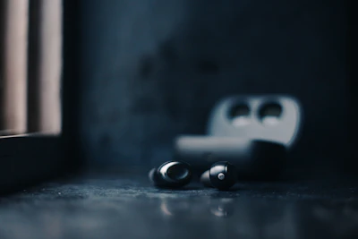 a pair of ear buds sitting on a table next to a window