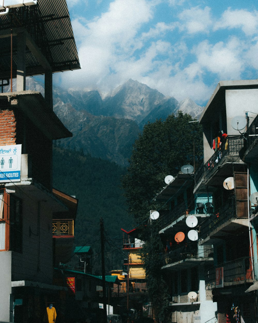 a group of buildings with mountains in the background