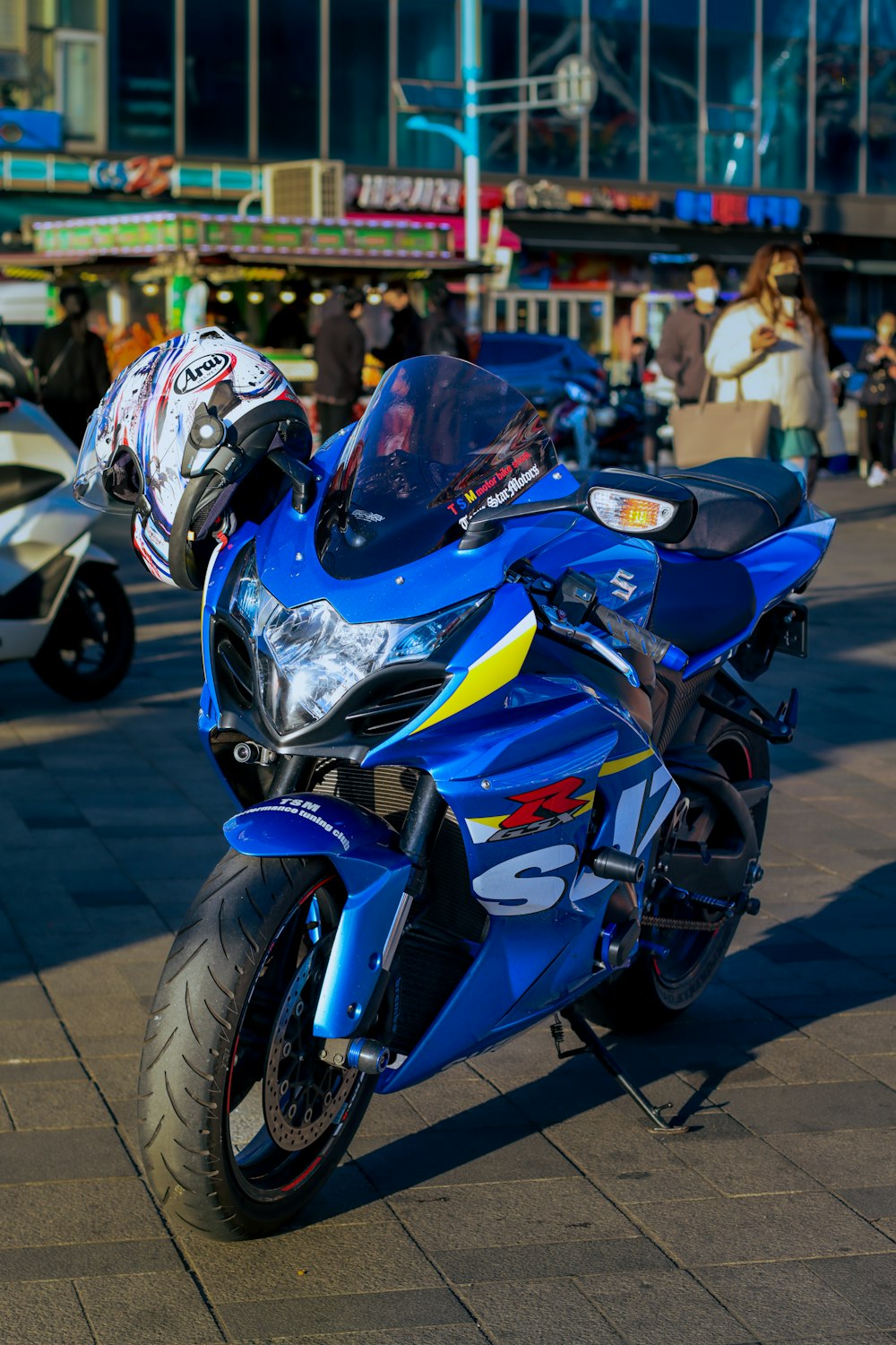 a blue motorcycle parked on the side of a road