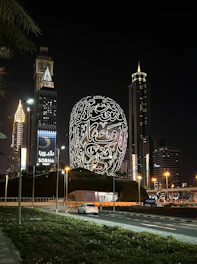 a building with a giant ball in the middle of a city