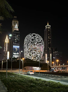 a building with a giant ball in the middle of a city