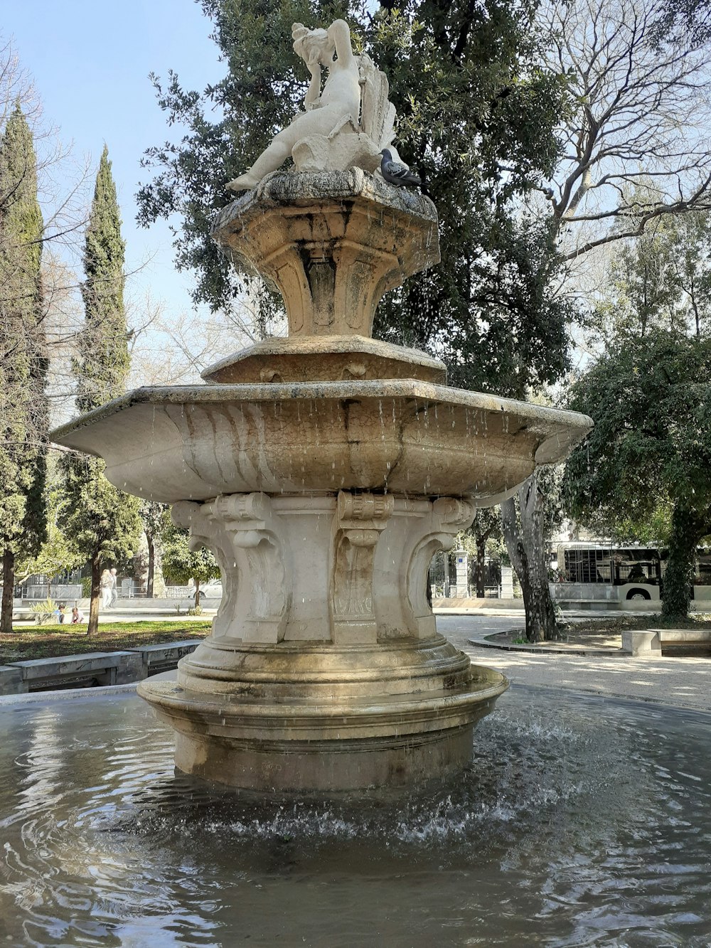 a water fountain with a statue on top of it