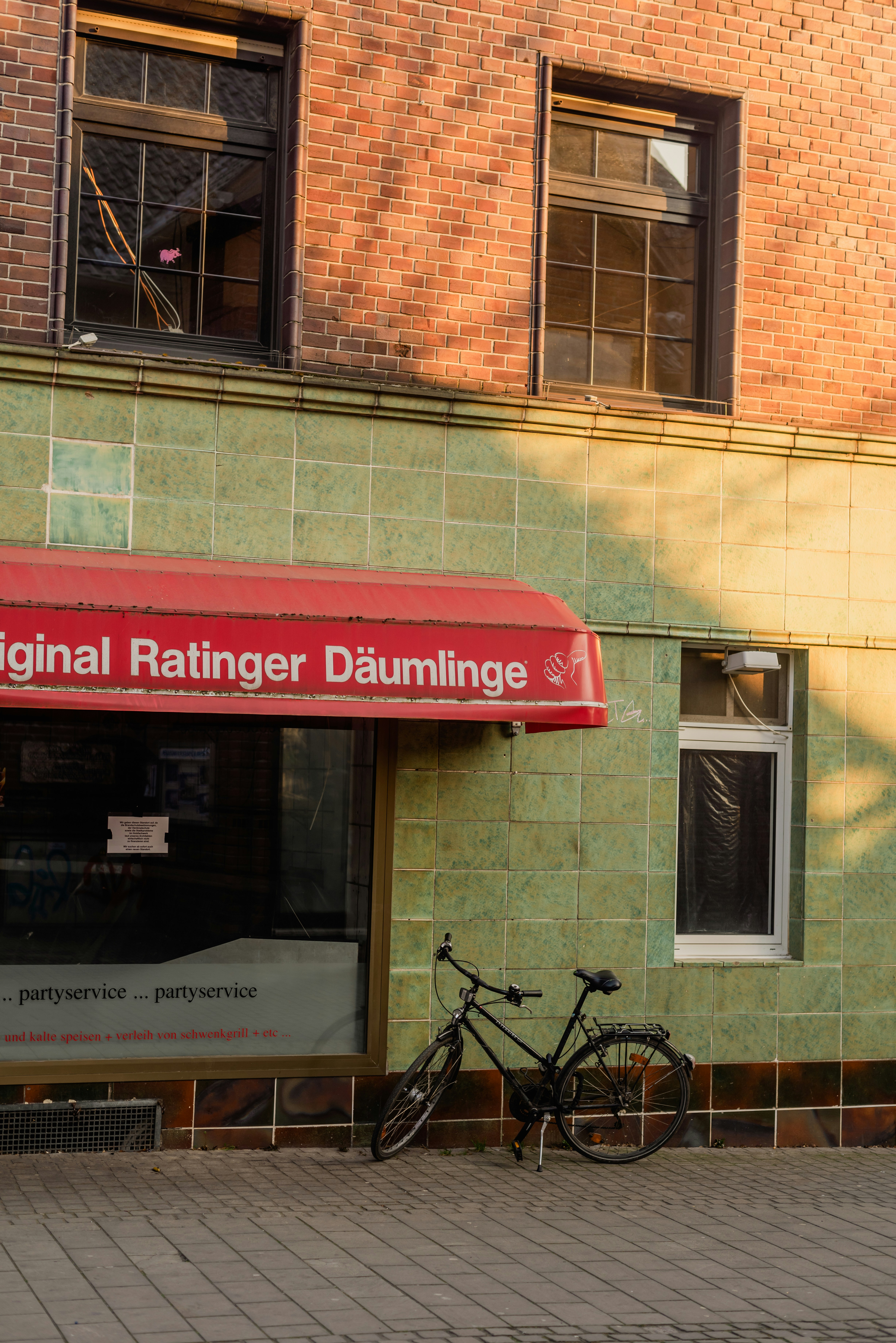 a bicycle parked in front of a brick building