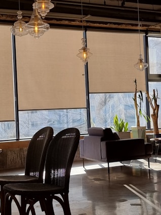 A stylish roller shade in a modern living room setting.