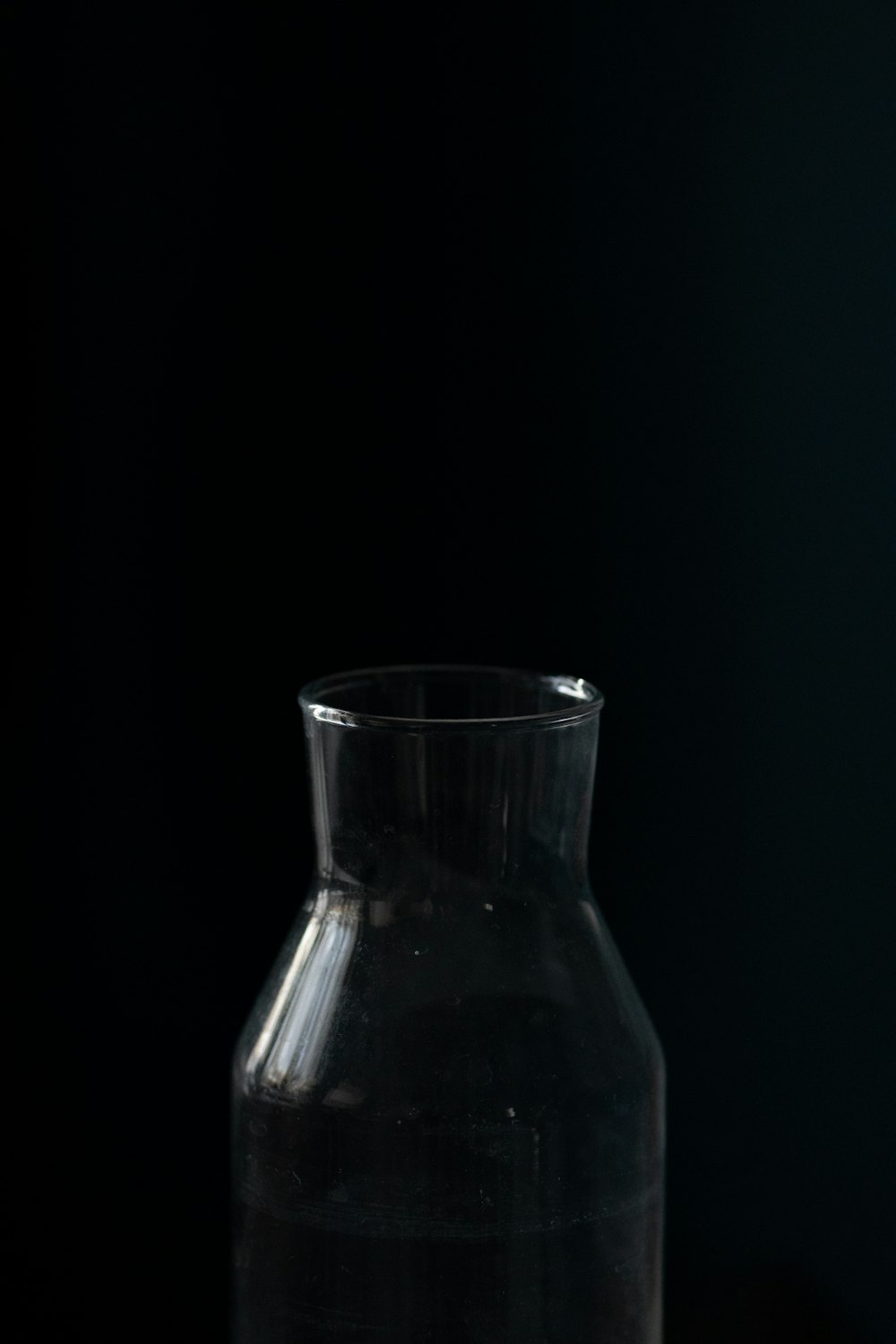 a glass vase sitting on top of a wooden table