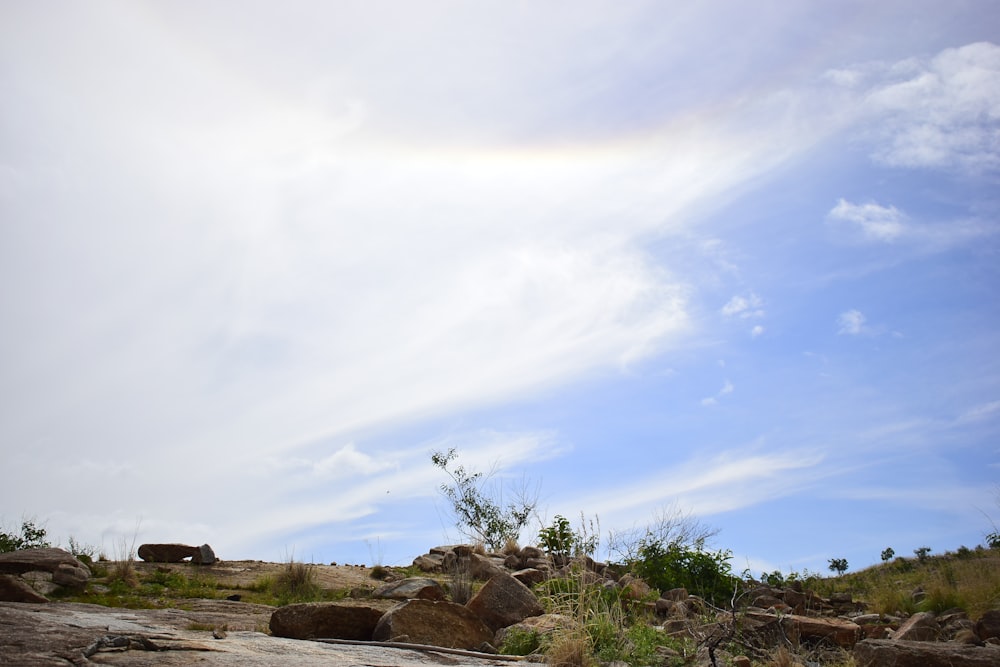 there is a rainbow in the sky above the rocks