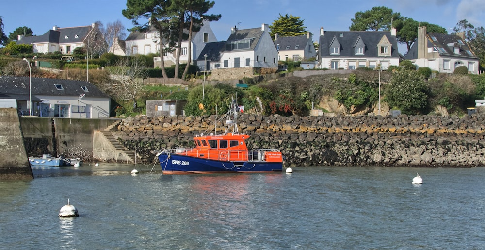 a blue and orange boat in a body of water