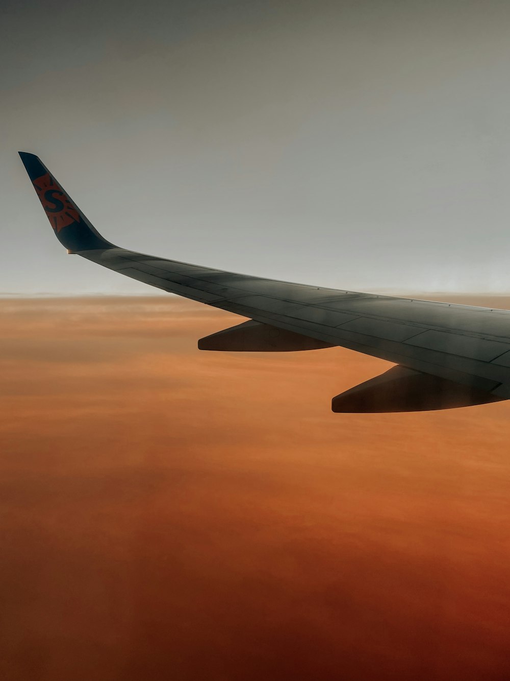 a view of the wing of an airplane in the sky