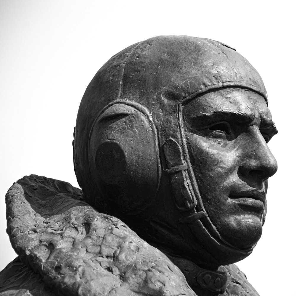 a close up of a statue of a man wearing a helmet