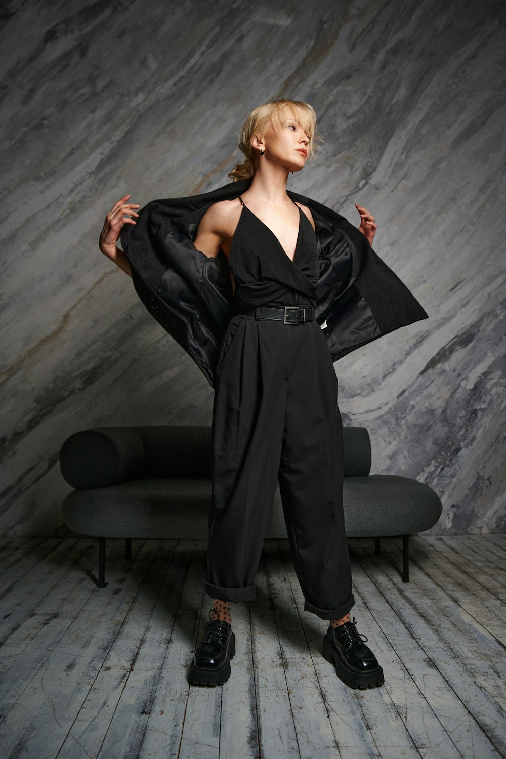 a woman in a black jumpsuit posing for a picture