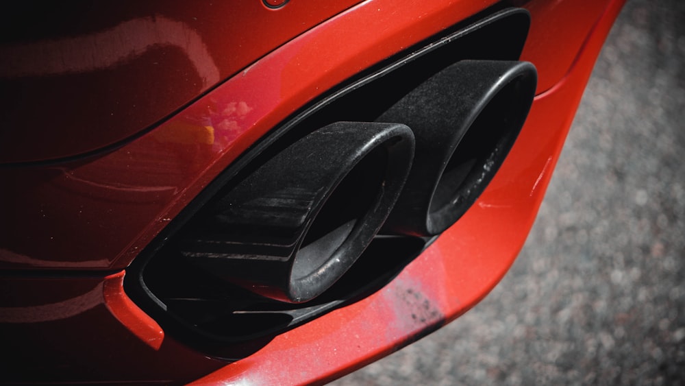 a close up of a red car's front bumper