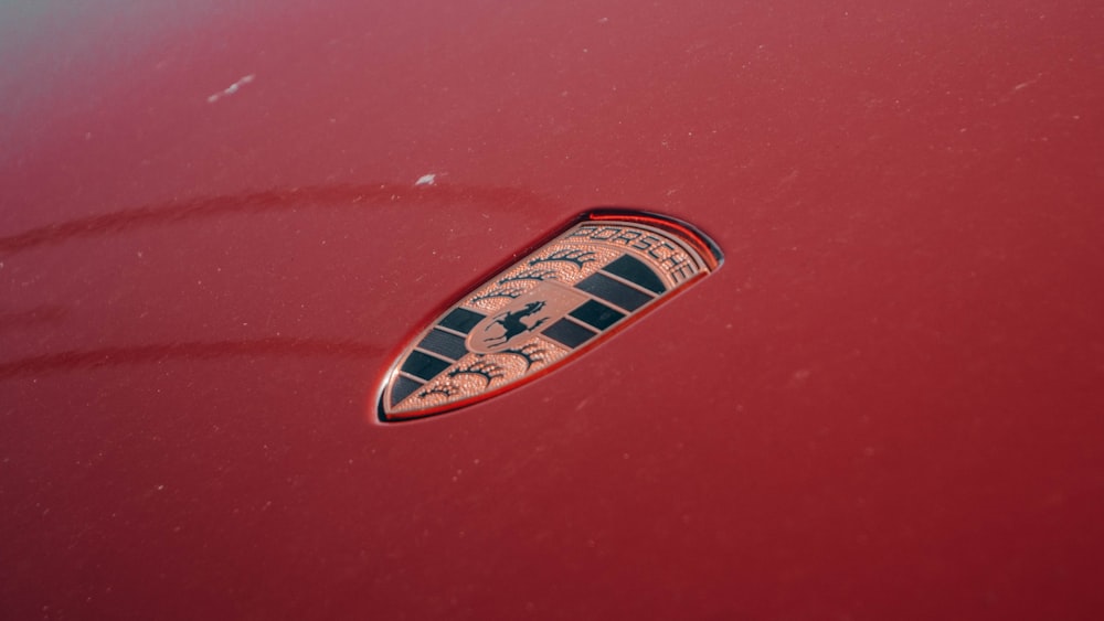 a close up of the emblem on a red car