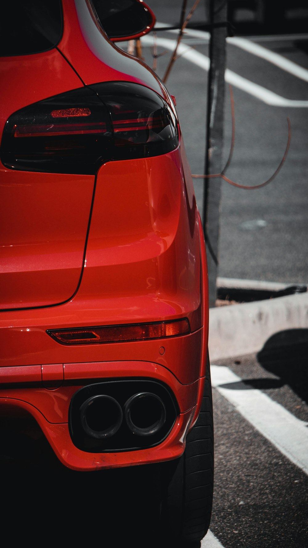 a red sports car parked on the side of the road