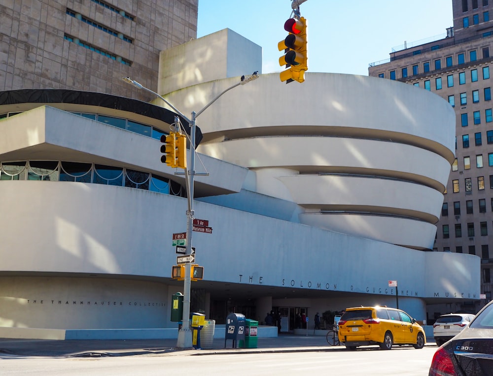 a yellow car is parked in front of a building