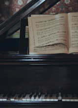 an open book sitting on top of a piano