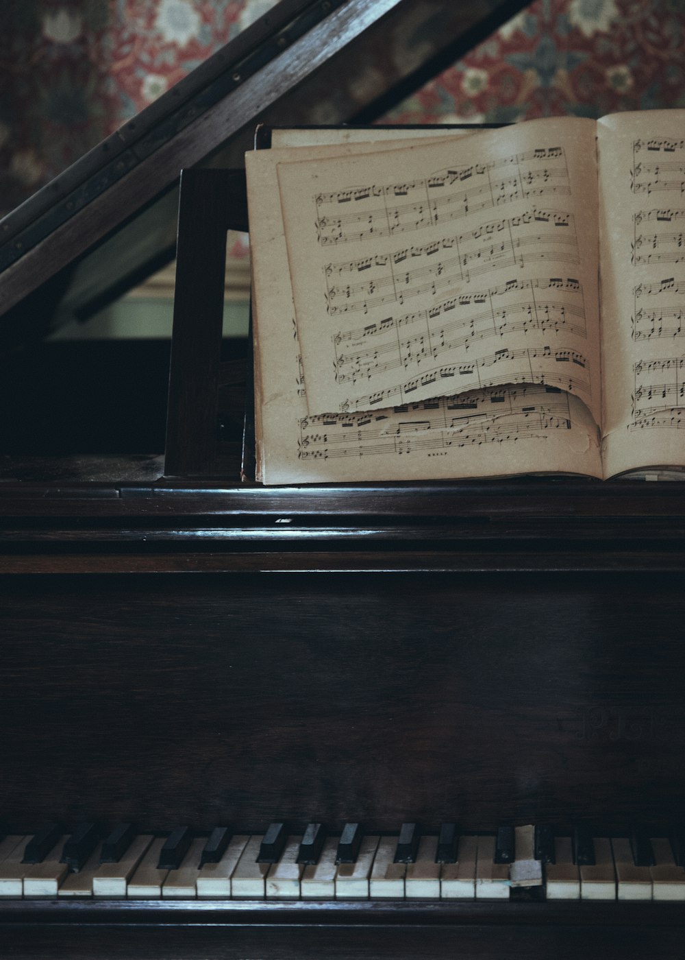 an open book sitting on top of a piano