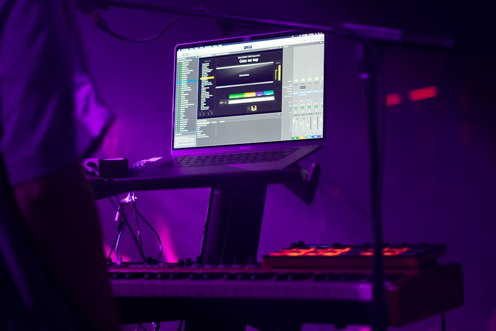 a laptop computer sitting on top of a keyboard