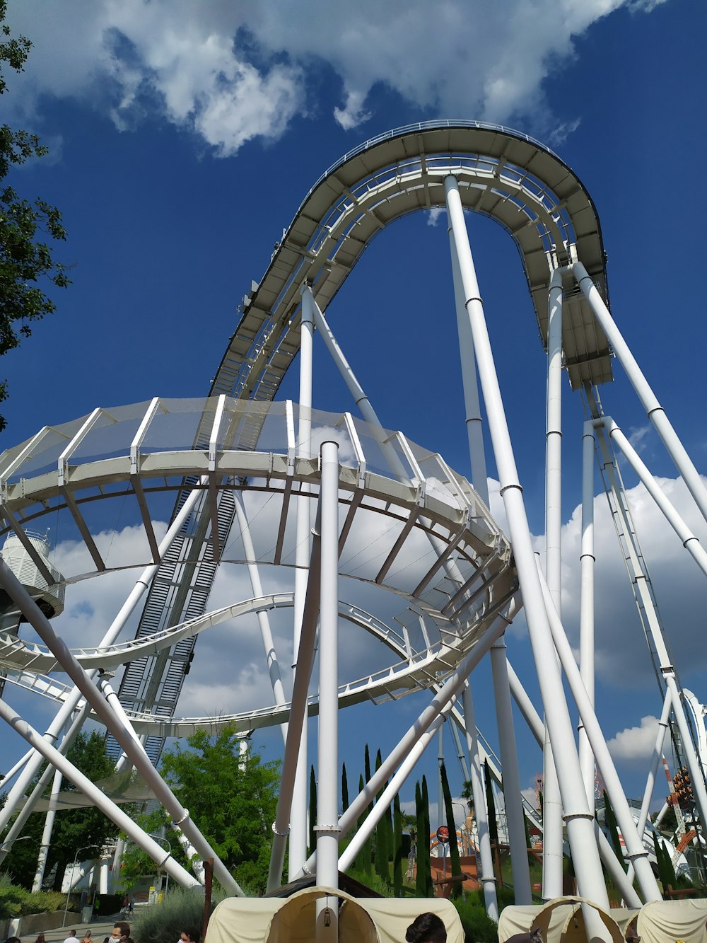 a roller coaster in a park with a sky background