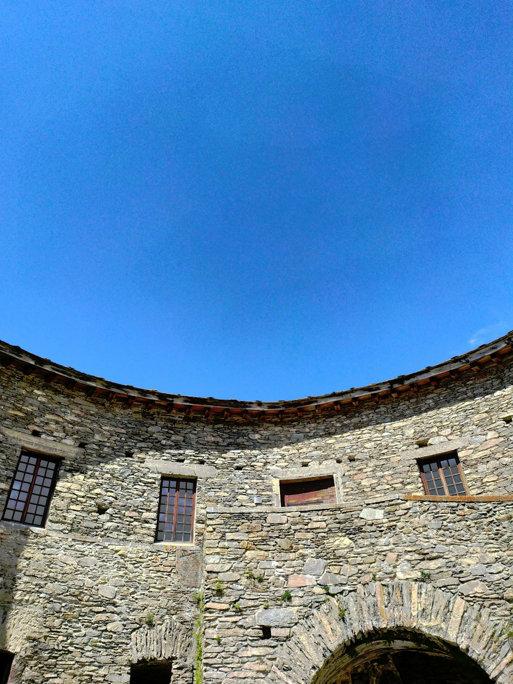 a stone building with a clock on the front of it