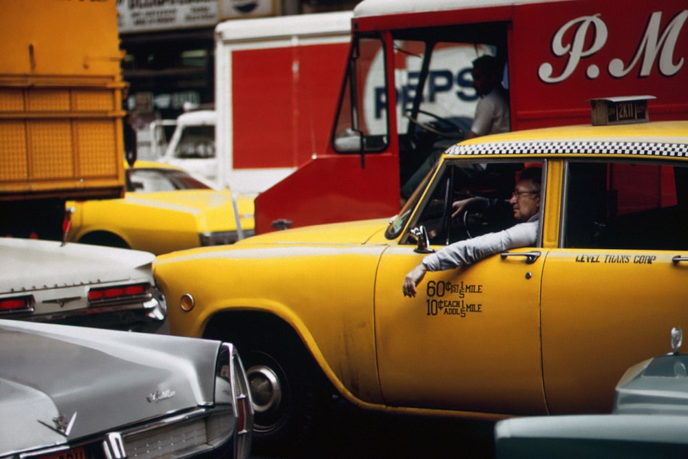 a taxi cab driving down a busy street